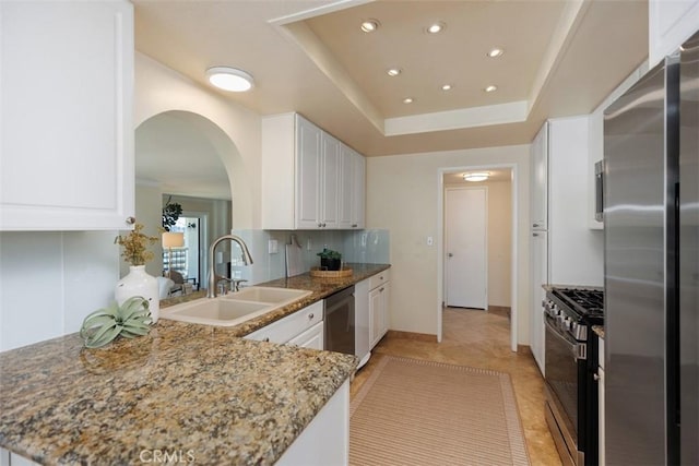 22364 Manacor Unit 9, Mission Viejo, CA 92692 - kitchen featuring appliances with stainless steel finishes, a sink, arched walkways, recessed lighting, and white cabinetry