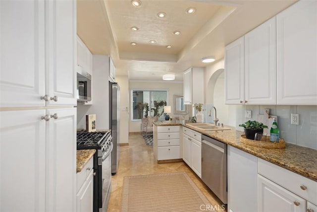 22364 Manacor Unit 9, Mission Viejo, CA 92692 - kitchen featuring a sink, appliances with stainless steel finishes, a tray ceiling, white cabinetry, and recessed lighting