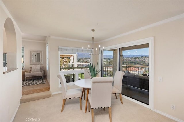 22364 Manacor Unit 9, Mission Viejo, CA 92692 - dining room featuring ornamental molding, a chandelier, light colored carpet, baseboards, and arched walkways