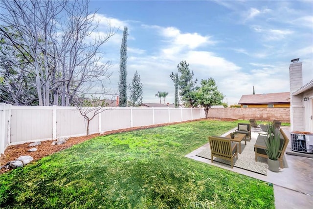 view of yard with a fenced backyard, central AC unit, an outdoor hangout area, and a patio