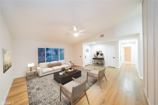 living room with a ceiling fan, baseboards, visible vents, vaulted ceiling, and light wood-type flooring