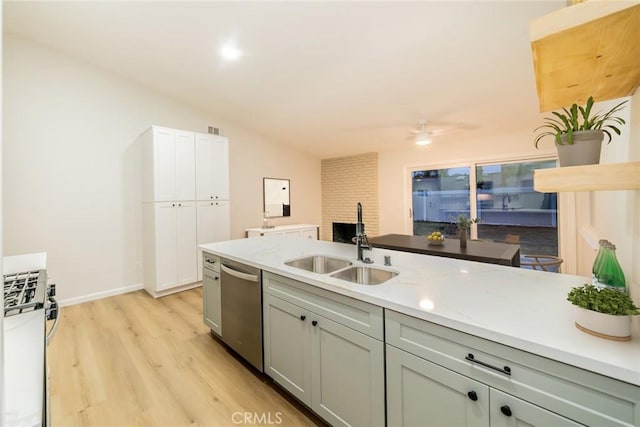 kitchen featuring visible vents, vaulted ceiling, light wood-style floors, stainless steel appliances, and a sink