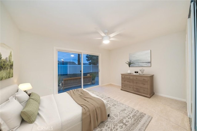 carpeted bedroom featuring baseboards, a ceiling fan, and access to outside