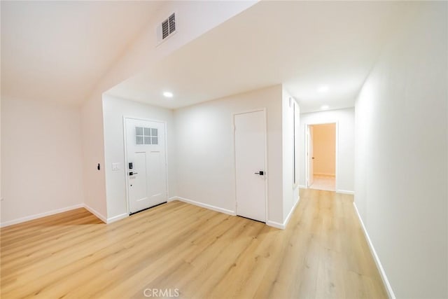 foyer featuring visible vents, baseboards, and light wood-style floors