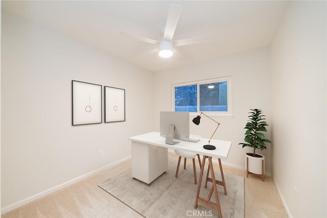 home office with light colored carpet, baseboards, and ceiling fan