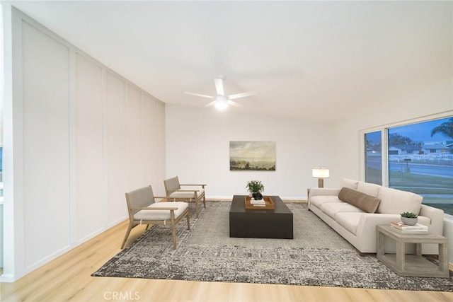 living room with a ceiling fan and wood finished floors