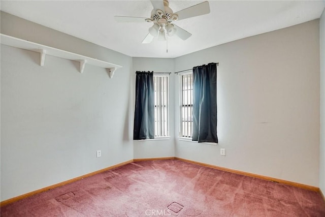 unfurnished room featuring a ceiling fan, baseboards, and carpet floors