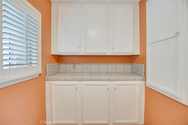 kitchen with white cabinets and tile countertops