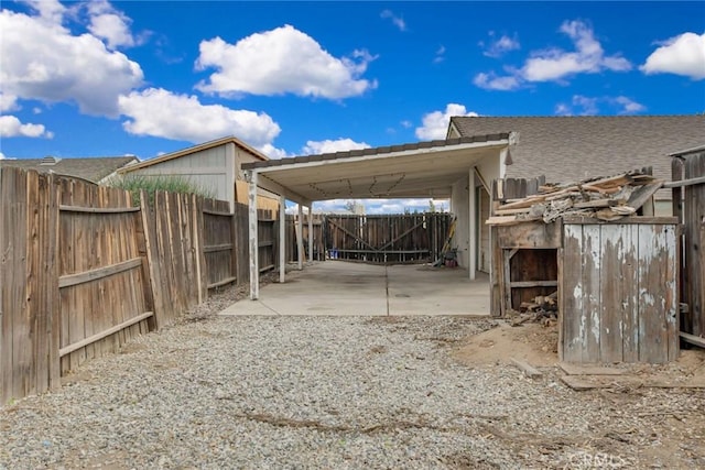 view of patio featuring a carport and a fenced backyard