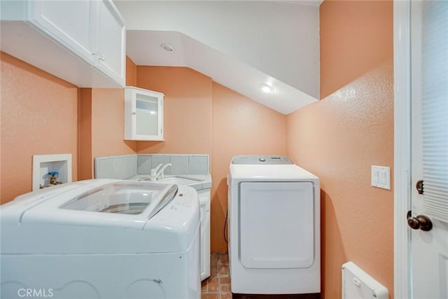 washroom featuring washing machine and dryer and cabinet space