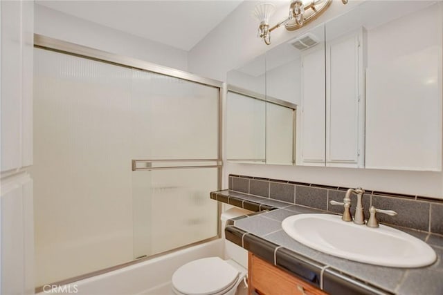 bathroom with visible vents, enclosed tub / shower combo, toilet, and vanity