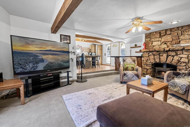 living room featuring beamed ceiling, carpet flooring, and ceiling fan