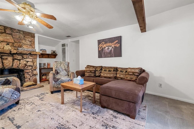 carpeted living area featuring a ceiling fan, baseboards, visible vents, lofted ceiling with beams, and a fireplace