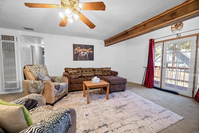 living room with beam ceiling, visible vents, a ceiling fan, and carpet floors