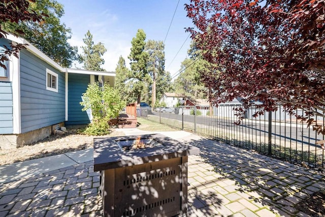 view of patio with fence and an outdoor fire pit