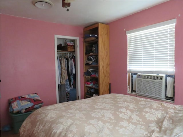 bedroom featuring cooling unit and a closet