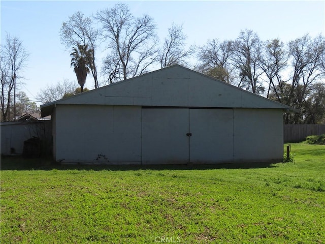 view of pole building featuring a yard and fence