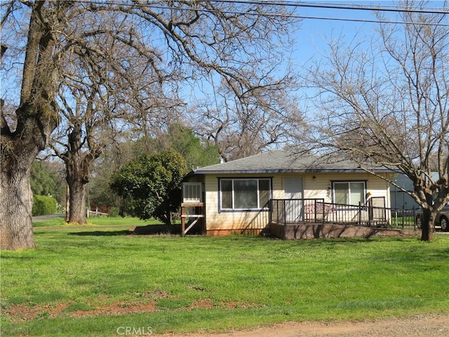 view of front of home featuring a deck and a front yard