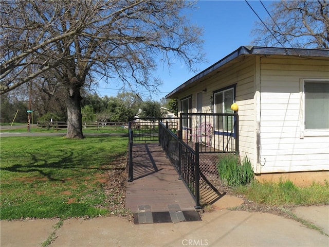 view of property exterior featuring a deck and a yard