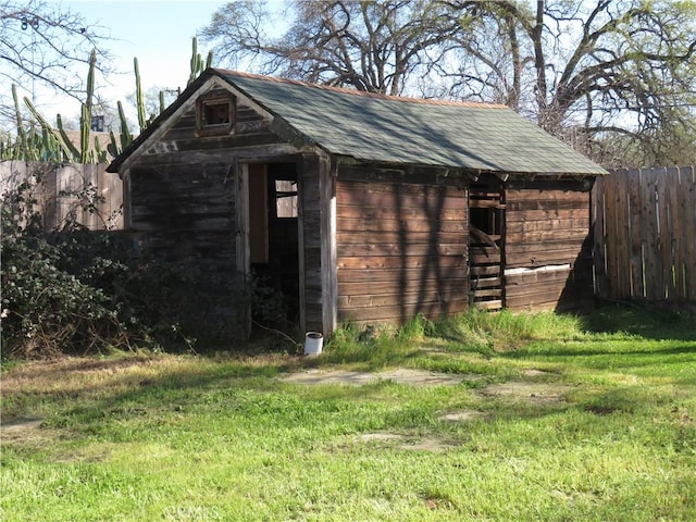 view of shed featuring fence