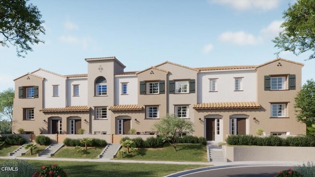 mediterranean / spanish-style home with stucco siding and a tile roof