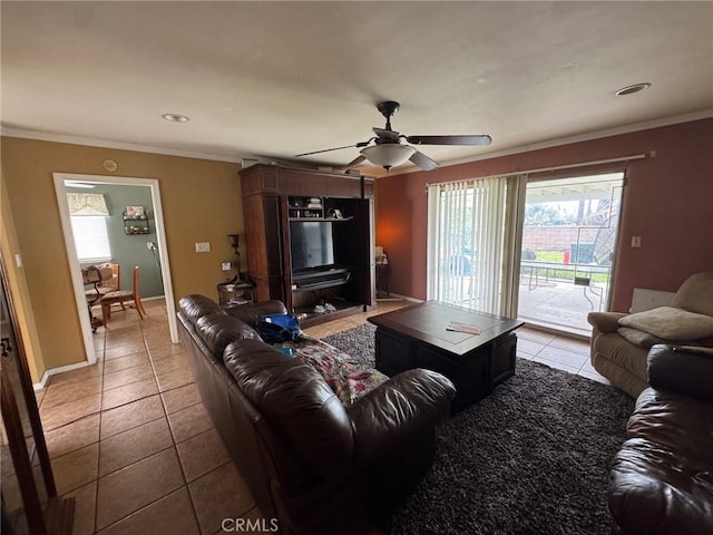 living room with light tile patterned floors, baseboards, a ceiling fan, and crown molding