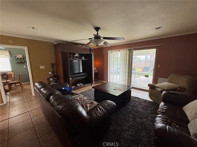 living area with tile patterned flooring, crown molding, and a ceiling fan