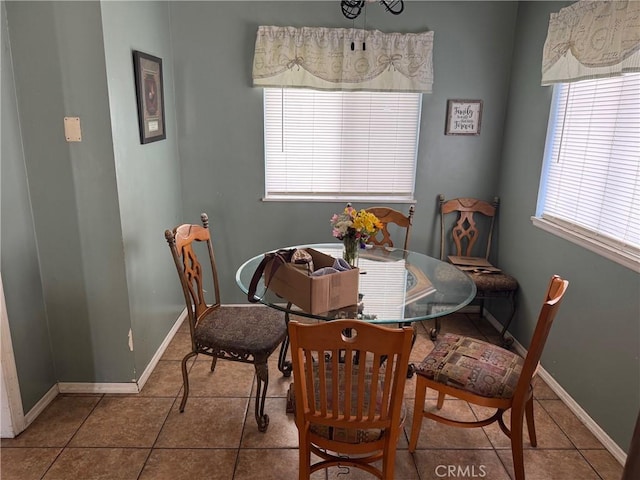 dining area featuring tile patterned floors and baseboards