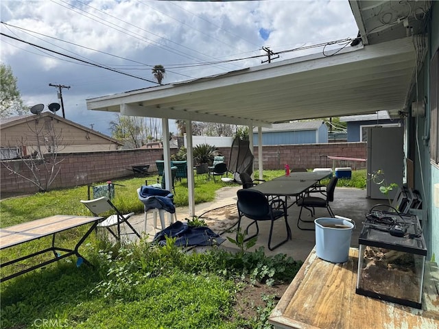 view of patio featuring outdoor dining space and a fenced backyard