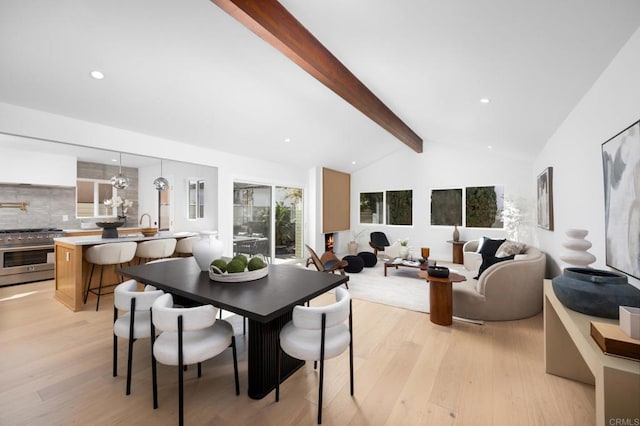 dining space with light wood finished floors, recessed lighting, and vaulted ceiling with beams