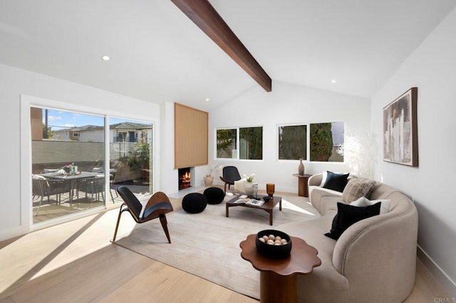 living area with baseboards, light wood-type flooring, lofted ceiling with beams, recessed lighting, and a fireplace