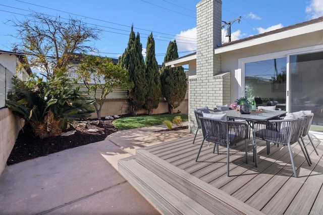 wooden terrace with a patio and fence