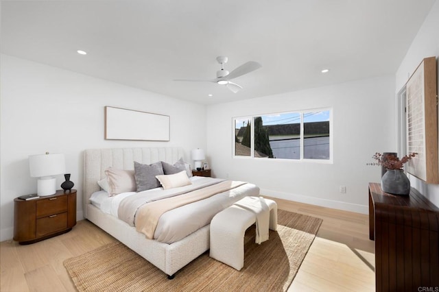 bedroom with recessed lighting, light wood-style flooring, a ceiling fan, and baseboards