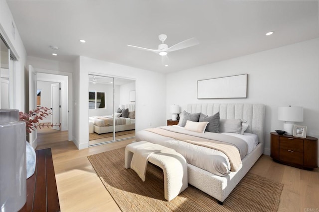 bedroom with a closet, recessed lighting, a ceiling fan, and light wood-style floors