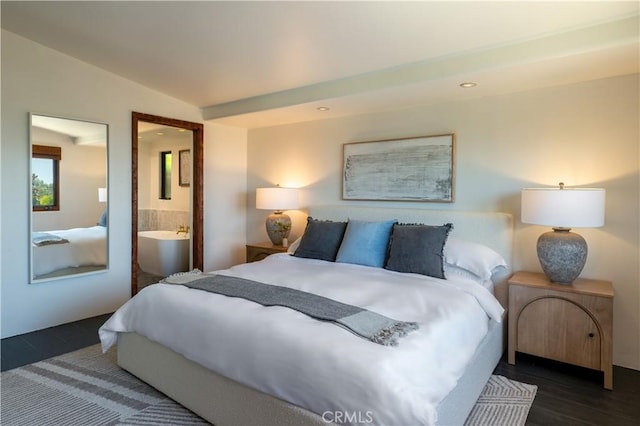 bedroom with connected bathroom, lofted ceiling, and wood finished floors