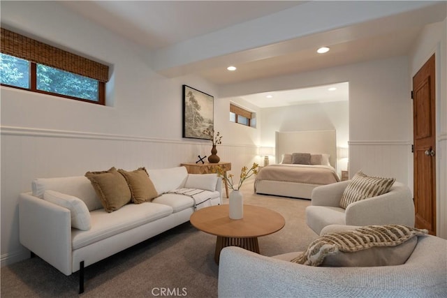 carpeted living area featuring beam ceiling, recessed lighting, and wainscoting