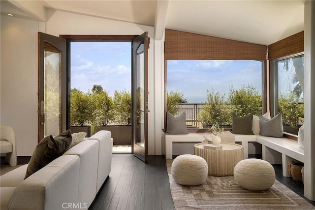 sunroom with a wealth of natural light and lofted ceiling