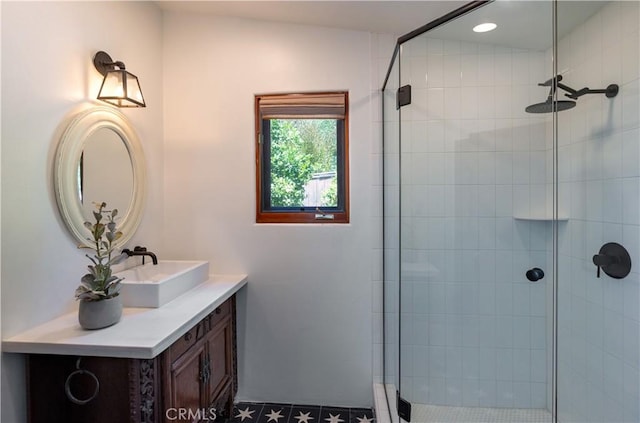 bathroom with recessed lighting, tiled shower, and vanity