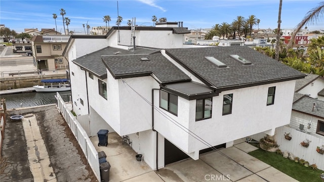 exterior space featuring a residential view and a water view