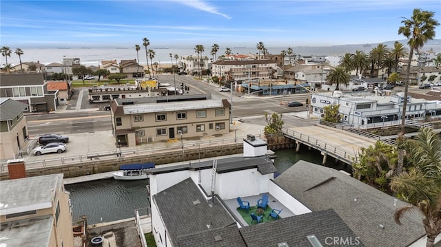 drone / aerial view with a water view and a residential view