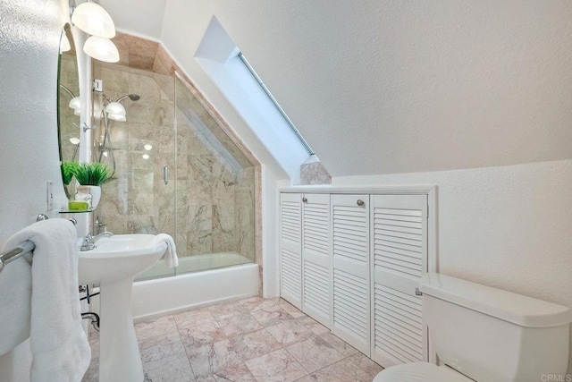 bathroom featuring toilet, vaulted ceiling, a textured wall, enclosed tub / shower combo, and marble finish floor