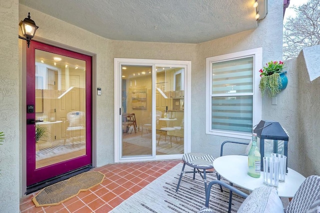 view of exterior entry featuring stucco siding