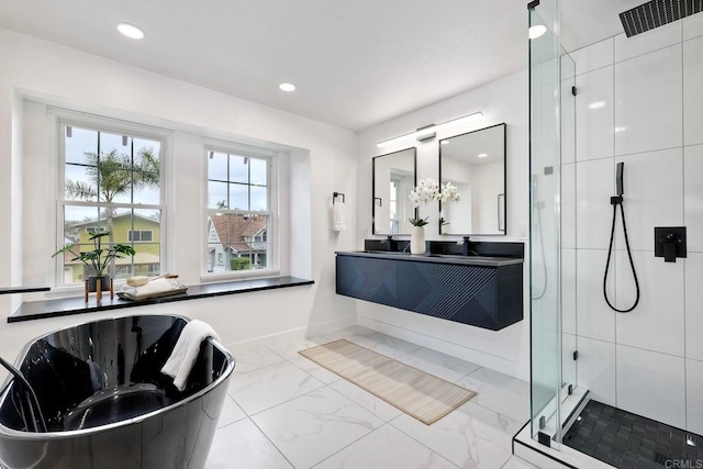 full bath with a freestanding tub, marble finish floor, recessed lighting, a shower stall, and vanity