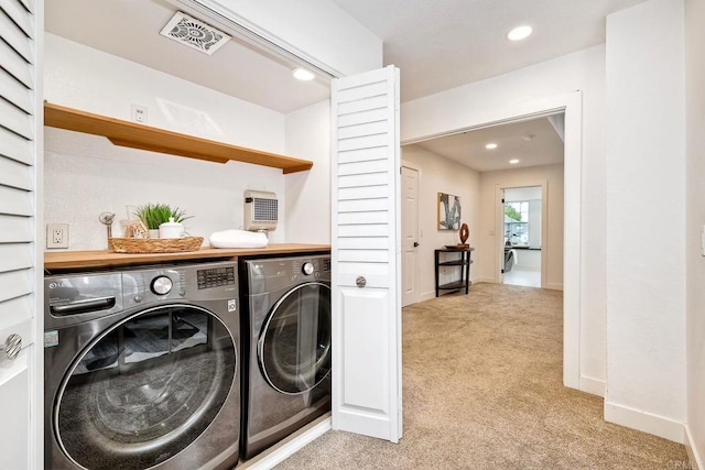 laundry room with visible vents, washing machine and dryer, recessed lighting, light colored carpet, and laundry area