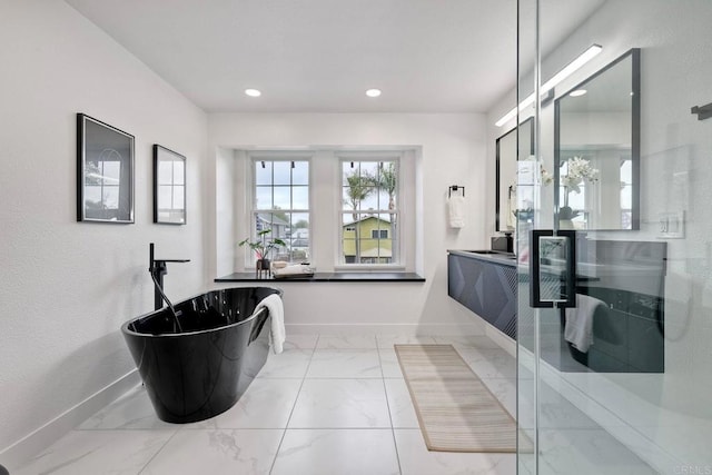 full bath featuring baseboards, a soaking tub, recessed lighting, a stall shower, and marble finish floor