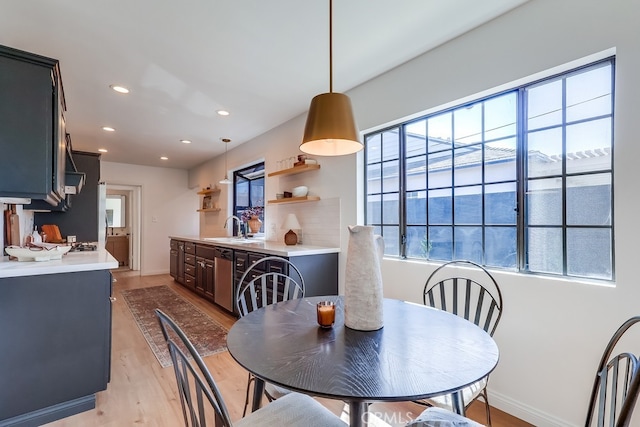 dining room with recessed lighting, baseboards, and light wood-style floors