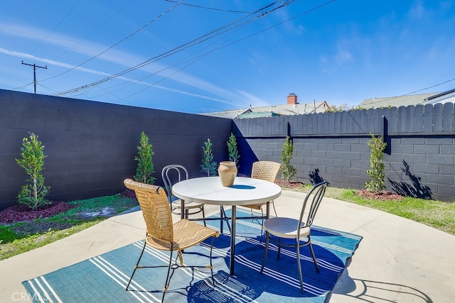 view of patio featuring a fenced backyard and outdoor dining space