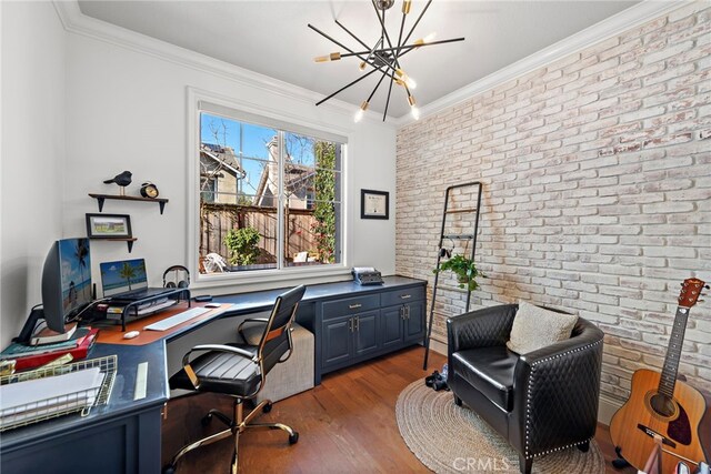 office area with an inviting chandelier, wood finished floors, brick wall, and ornamental molding