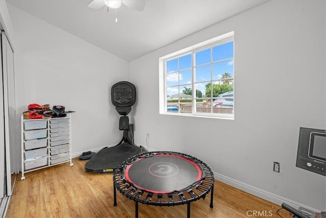 interior space with ceiling fan, baseboards, and wood finished floors