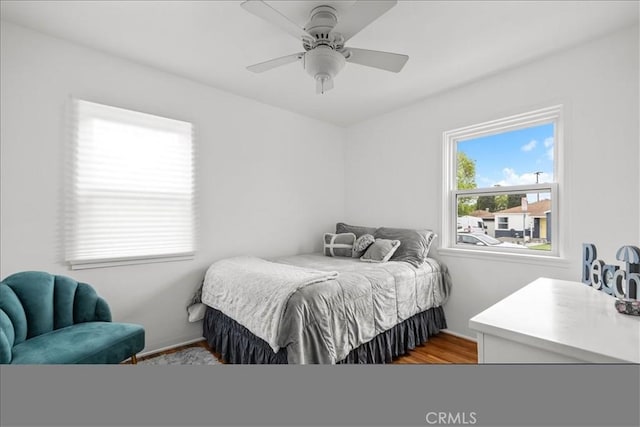 bedroom with a ceiling fan and wood finished floors